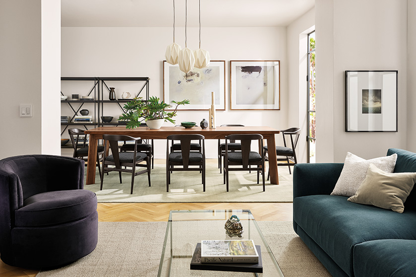 Dining room with Colby table, Evan chairs and Orikata pendants; beside living room with Otis swivel chair and Clemens sofa.