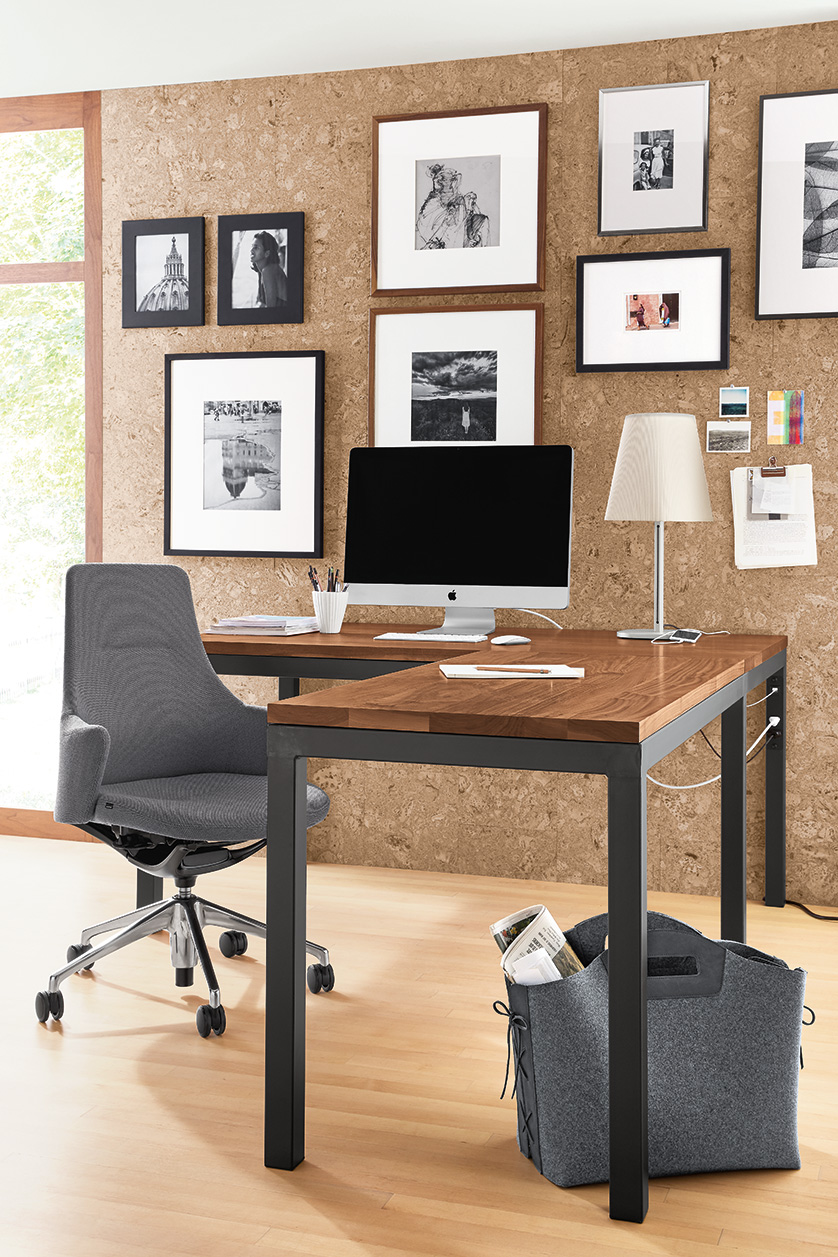 Home office with Parsons walnut L-shaped desk, LW Office Chair in grey, 
Barlow table lamp and a gallery wall of Profile picture frames.